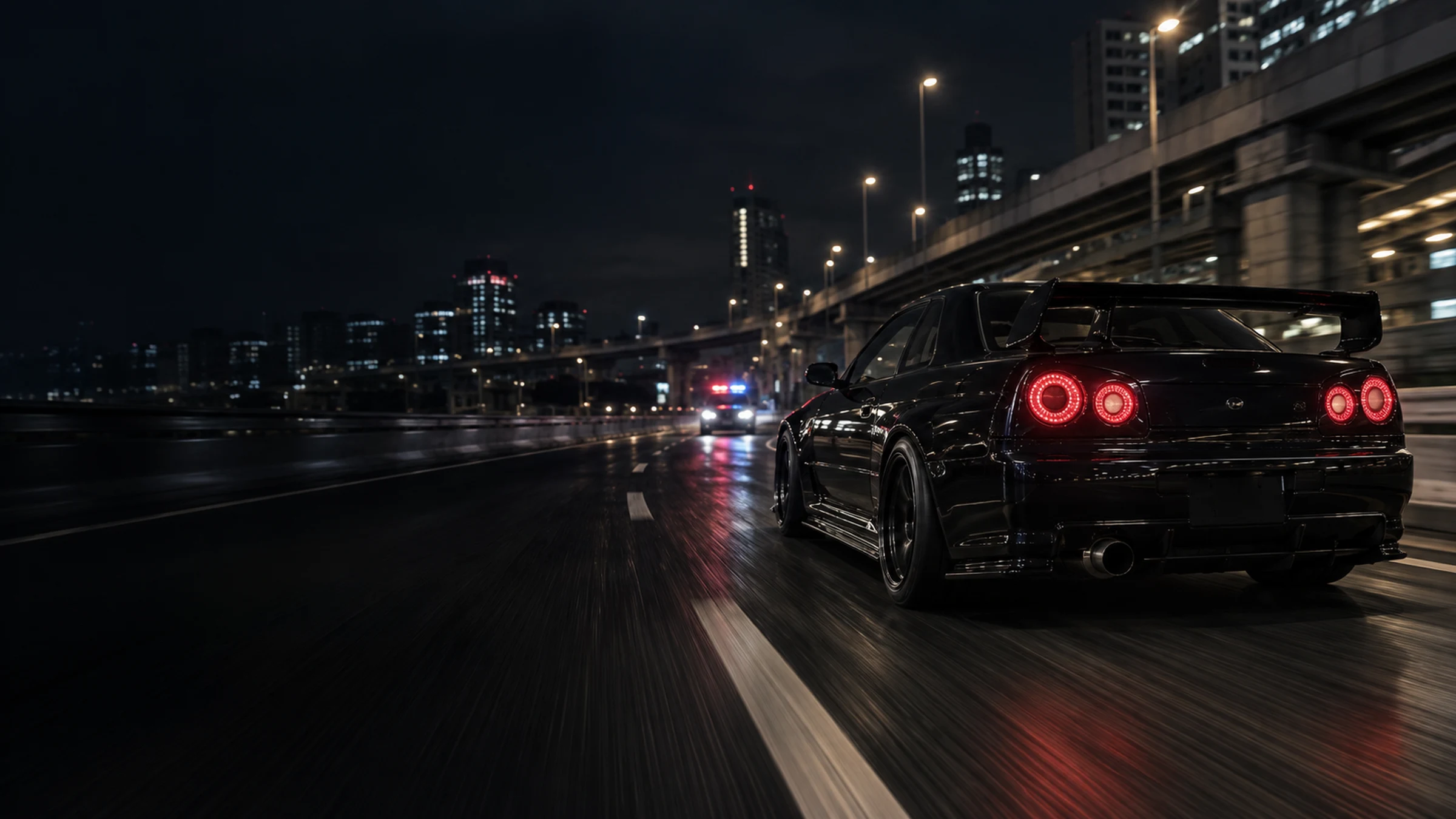 A black sports car on a Tokyo expressway at night